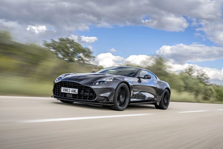 Aston Martin Vanquish in driekwart aanzicht rijdend op een landweg onder een bewolkte lucht
